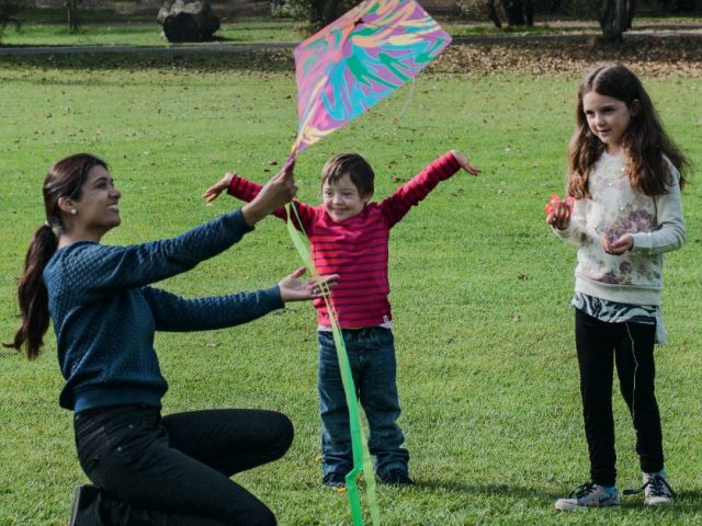 A family playing with a kite