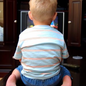 A young boy watching the TV