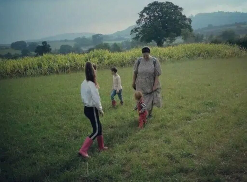 children in a field walking