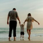 Ameiala dn Kai share their adoption journey, photo on beach from behind