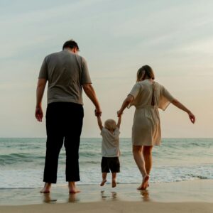 Ameiala dn Kai share their adoption journey, photo on beach from behind