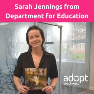 Sarah Jennings from Department for Education smiling and holding local 11 year old, Lillybelle's book about being adopted, called In My Own Words. 