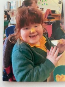 Bo at school balancing a crisp on her nose