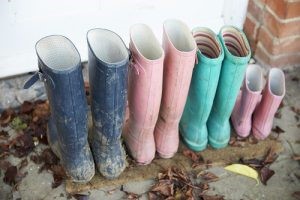 mudding wellies in different sizes, on a doorstep