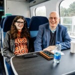 Carla and her dad Andrew, sat next to each other on a train