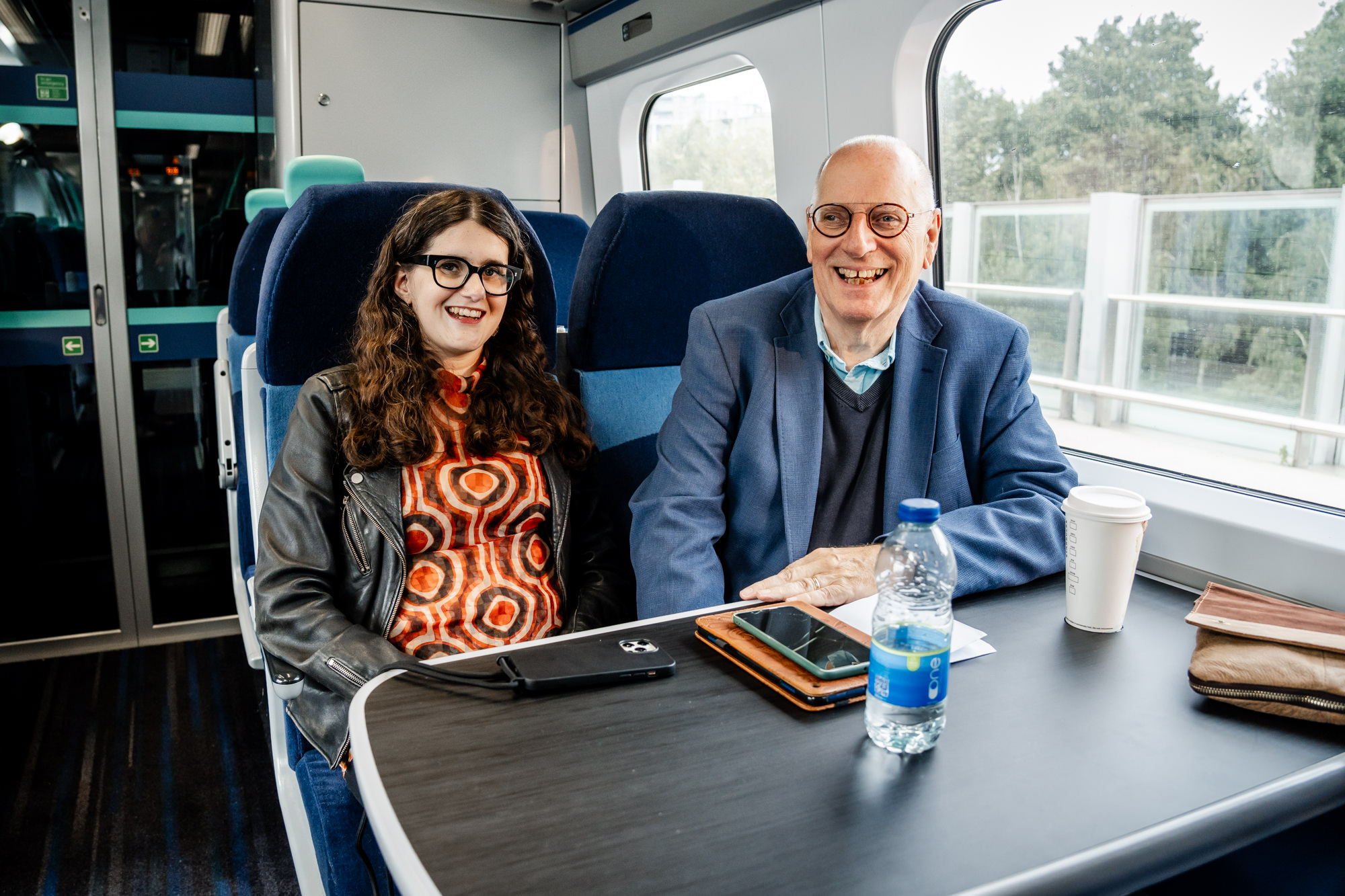Carla and her dad Andrew, sat next to each other on a train