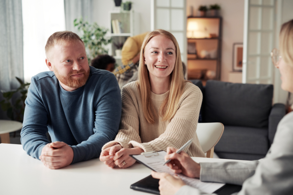 White couple in their early thirties talking with a social worker from adoption