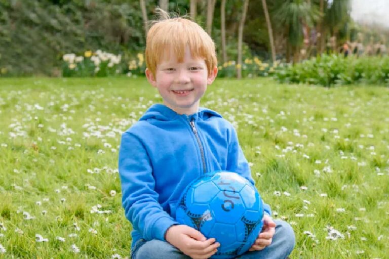 boy sitting on the grass
